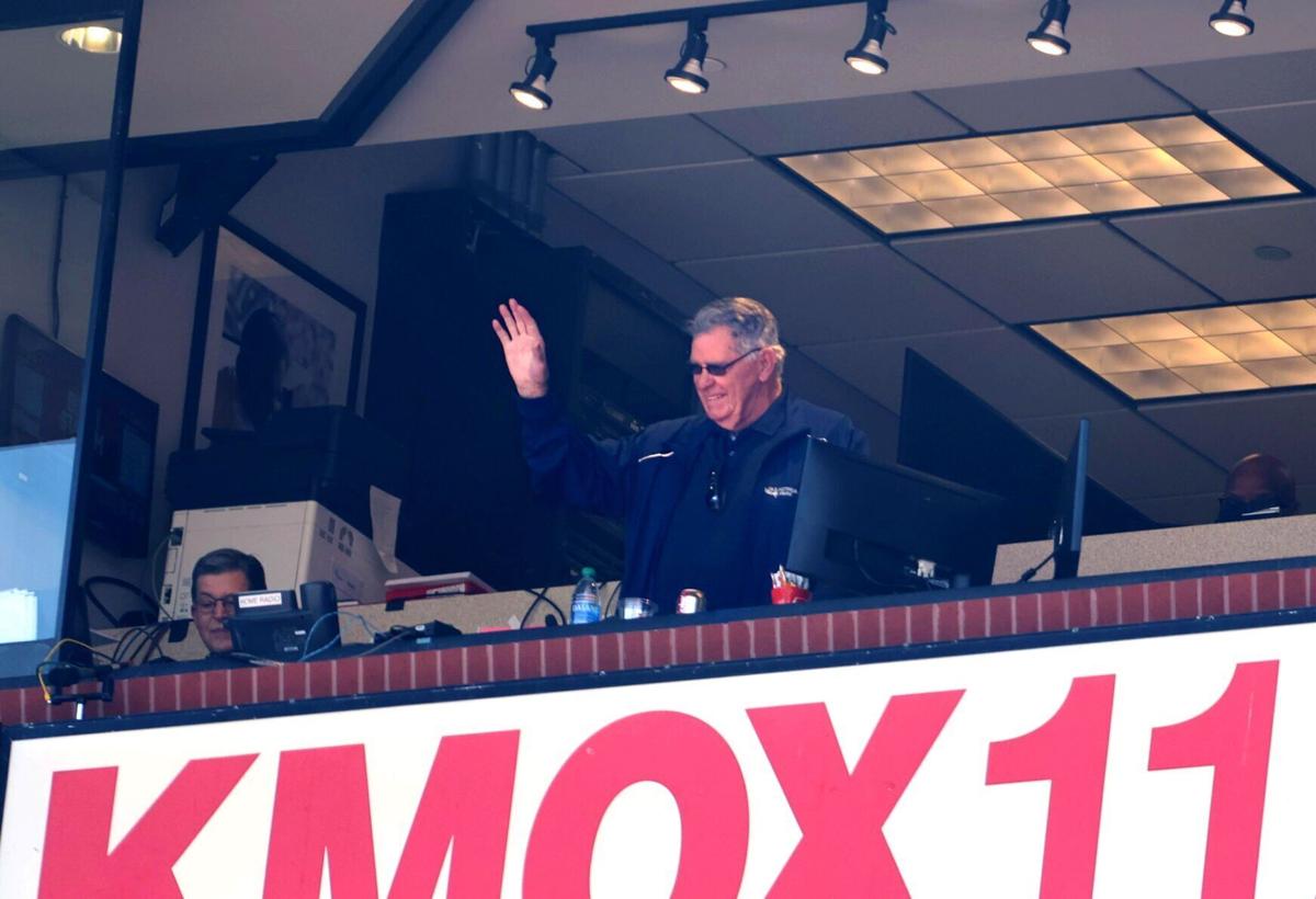 St. Louis Cardinals broadcaster Mike Shannon holds up a street