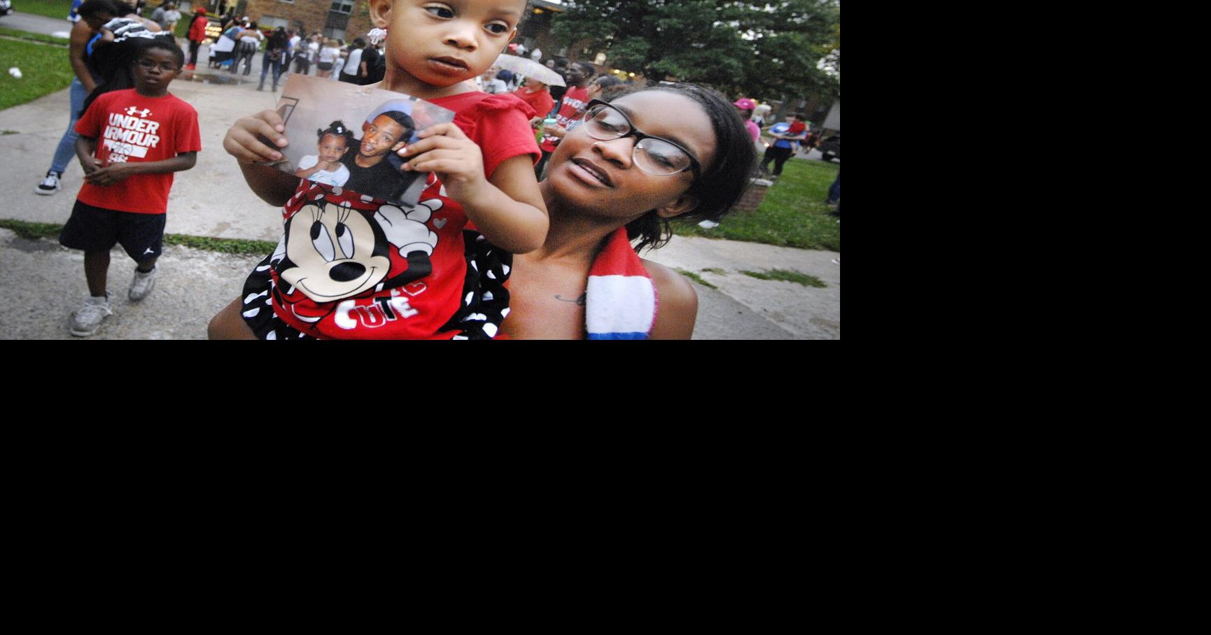Shooting victims mourned, answers sought at vigil