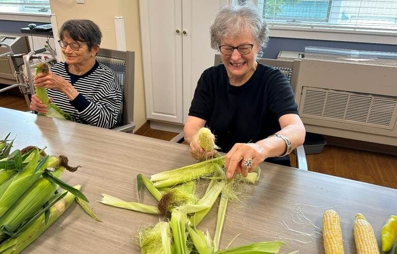 Gail and Margaret helped to get some sweet corn ready for a special addition to the menu.