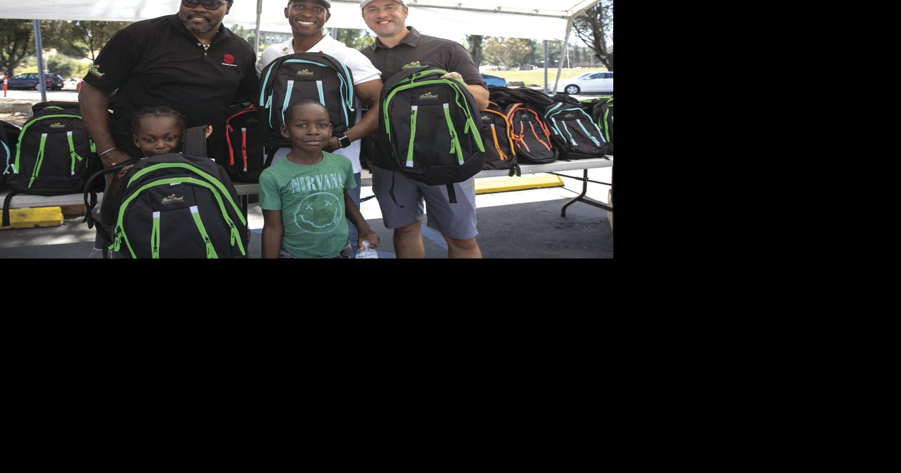 Lending a Hand: Rose Bowl site of backpack giveaway Feature Stories
