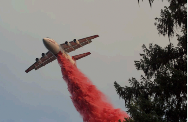 Dropping red fire retardant on fire pic