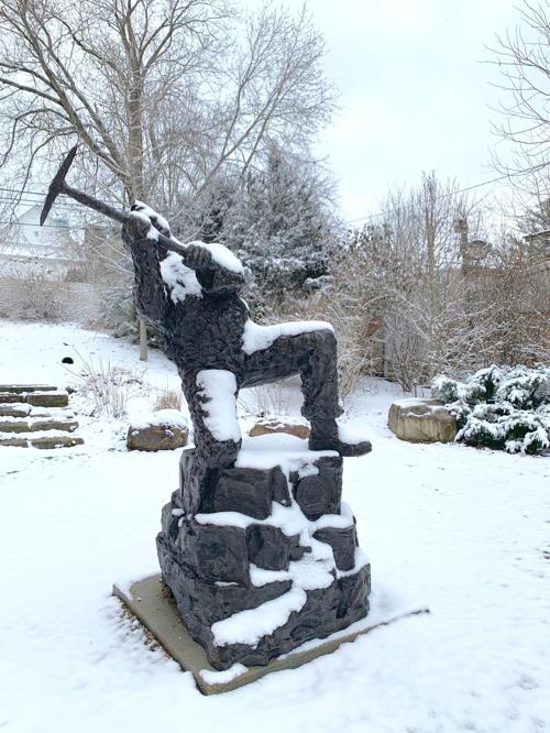 Snow-covered coal miner statue