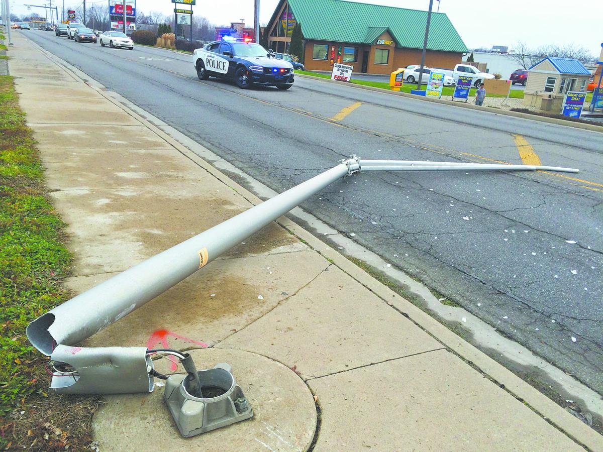 Crash causes light pole to fall onto East Market Street Local News