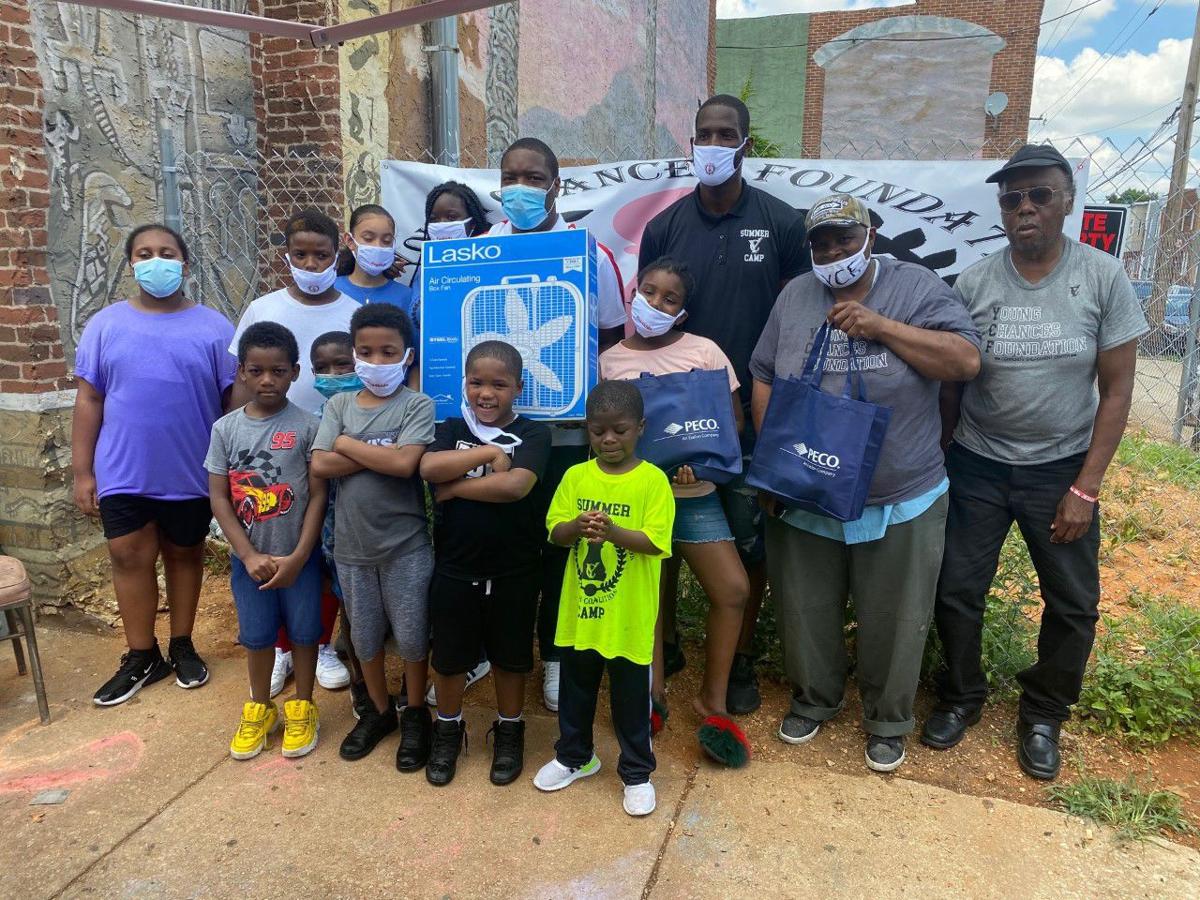 City Councilman Kenyatta Johnson and Tyrique Glagow, executive director of the Young Chances Foundation presented families in South Philadelphia with fans
