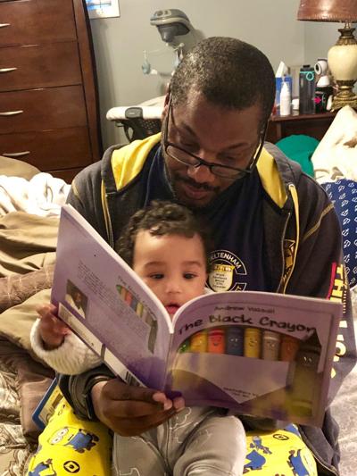 Andrew Vassall at home with his son