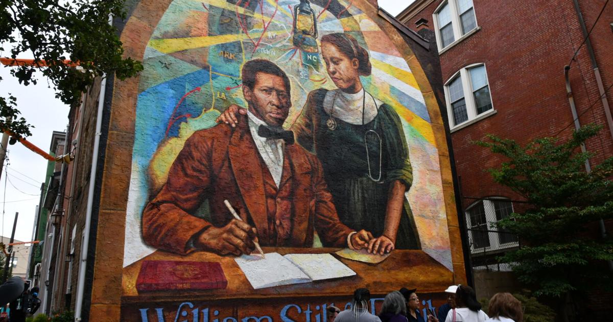 A mural featuring William Still and his wife signing a document