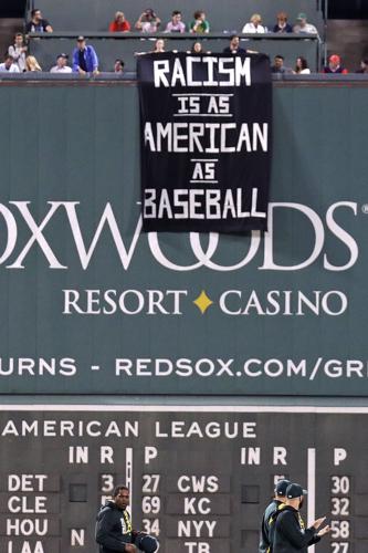 PHOTOS: Protesters Drape Racism Banner on Fenway Park's Green Monster