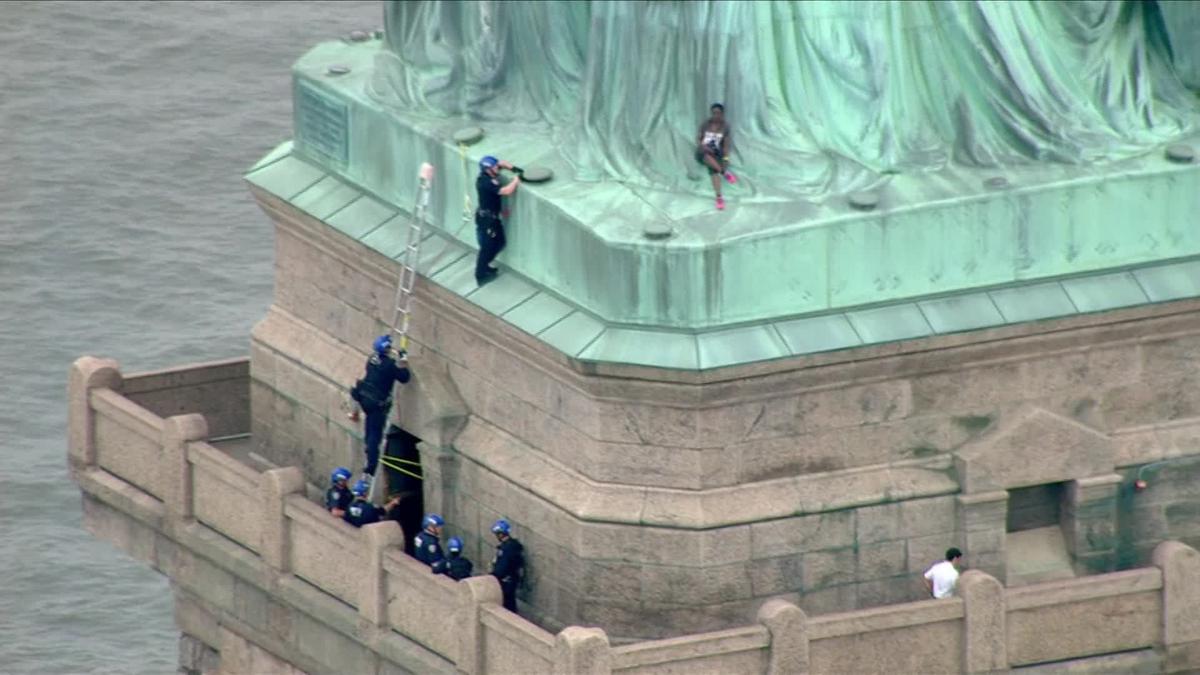 'Abolish ICE' protester's climb shuts down Statue of Liberty on July 4