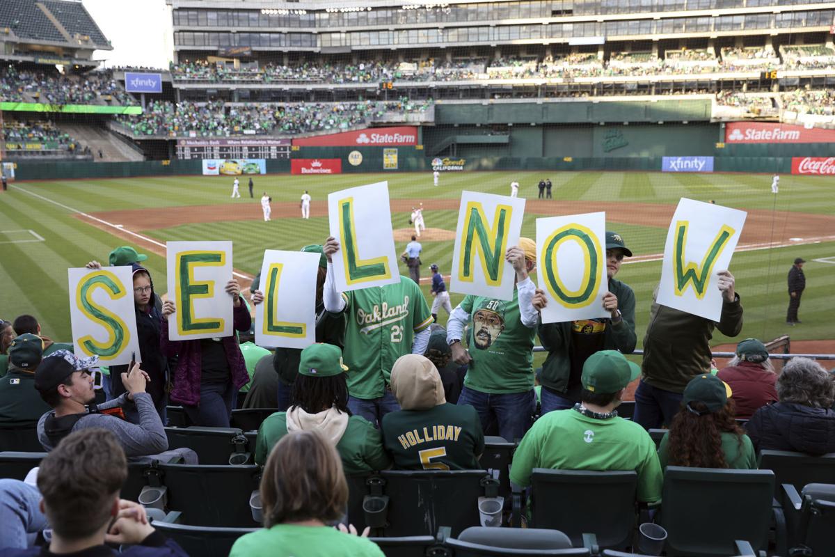 A's met by fans in Oakland with chants of `Sell the team!