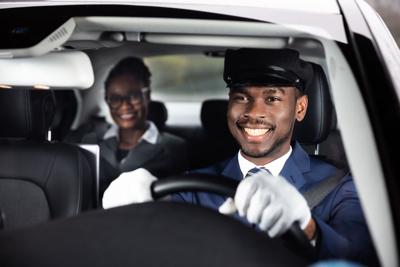 Close-up Of Happy Male Chauffeur Driving Car