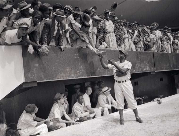 Jackie Robinson of the Brooklyn Dodgers signs autographs for kids at Braves  Field - Digital Commonwealth