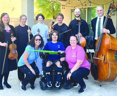 SW Lisa Maddock (left) Kirsta Johnson-Makowski (right) with patient Anthony and Phoenix Symphony musicians.jpg