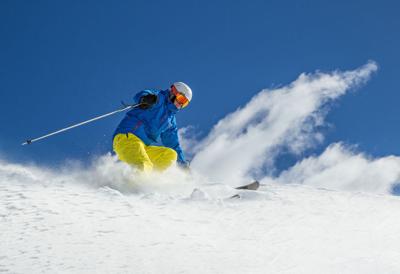 46807846 – skier skiing downhill during sunny day in high mountains