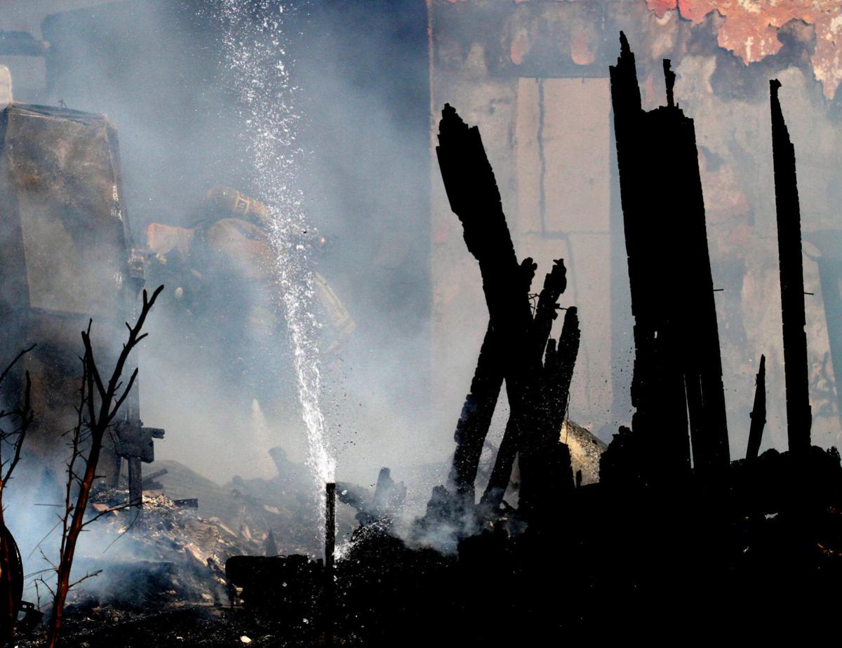House fire causes brush fire