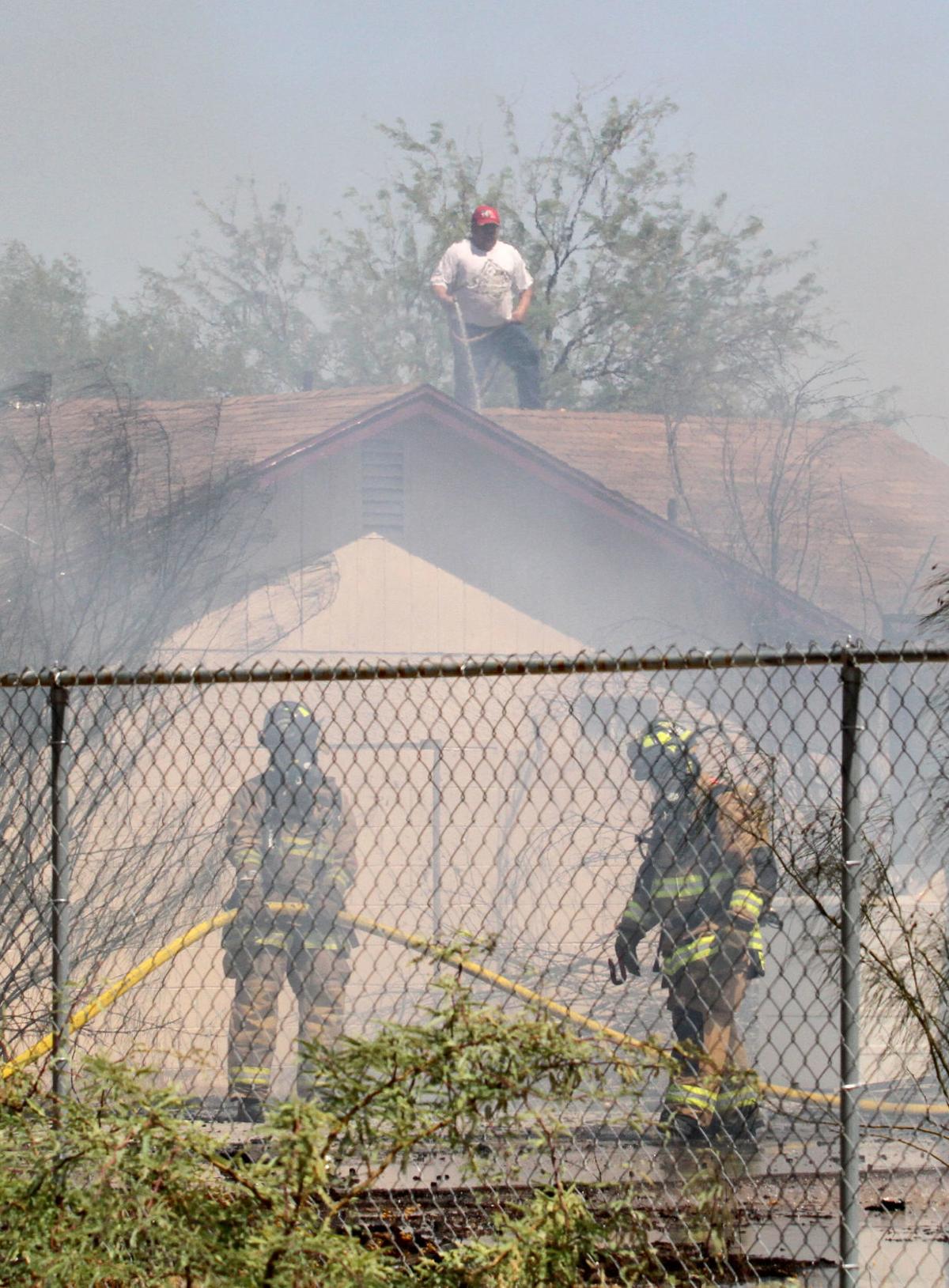 House fire causes brush fire