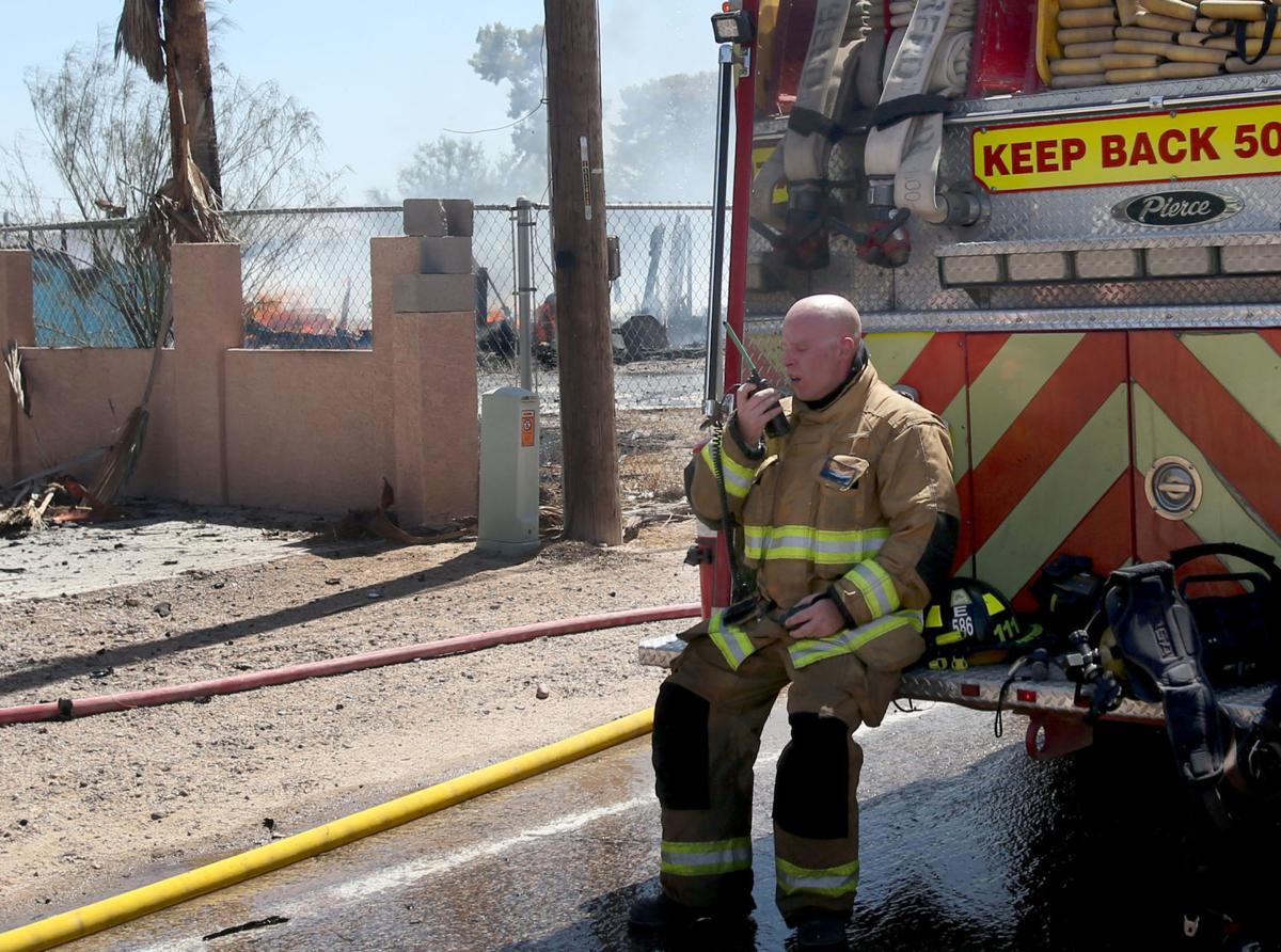 House fire causes brush fire