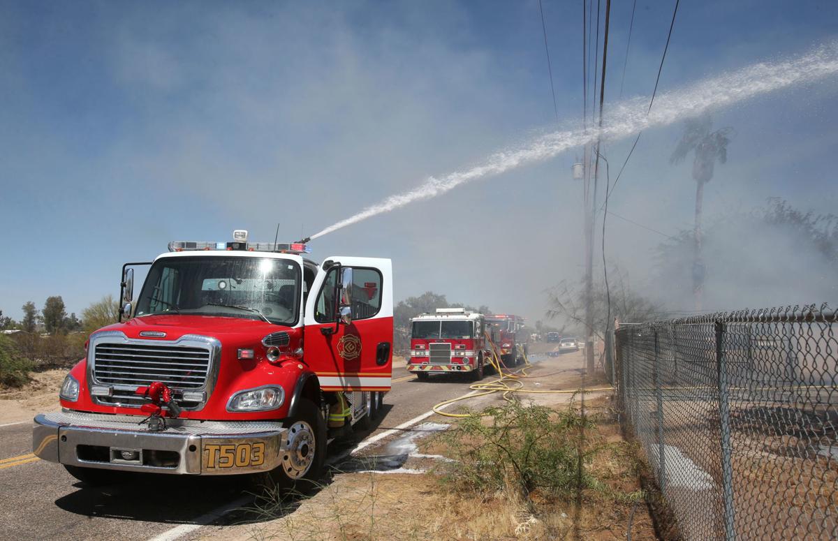 House fire causes brush fire