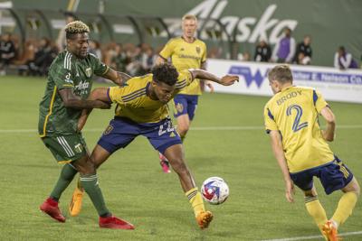 Dairon Asprilla fouls RSL defender and former Portland Pilot Delentz Pierre