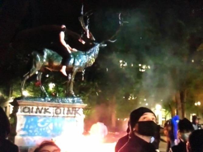 Elk Statue removed after fires set by protesters damage base