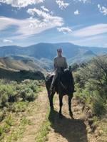 BLM officer rides the range on adopted horse