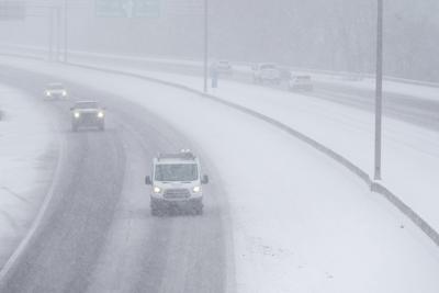 Powerful winter storm dumps heavy snow, causing flight delays, slick ...