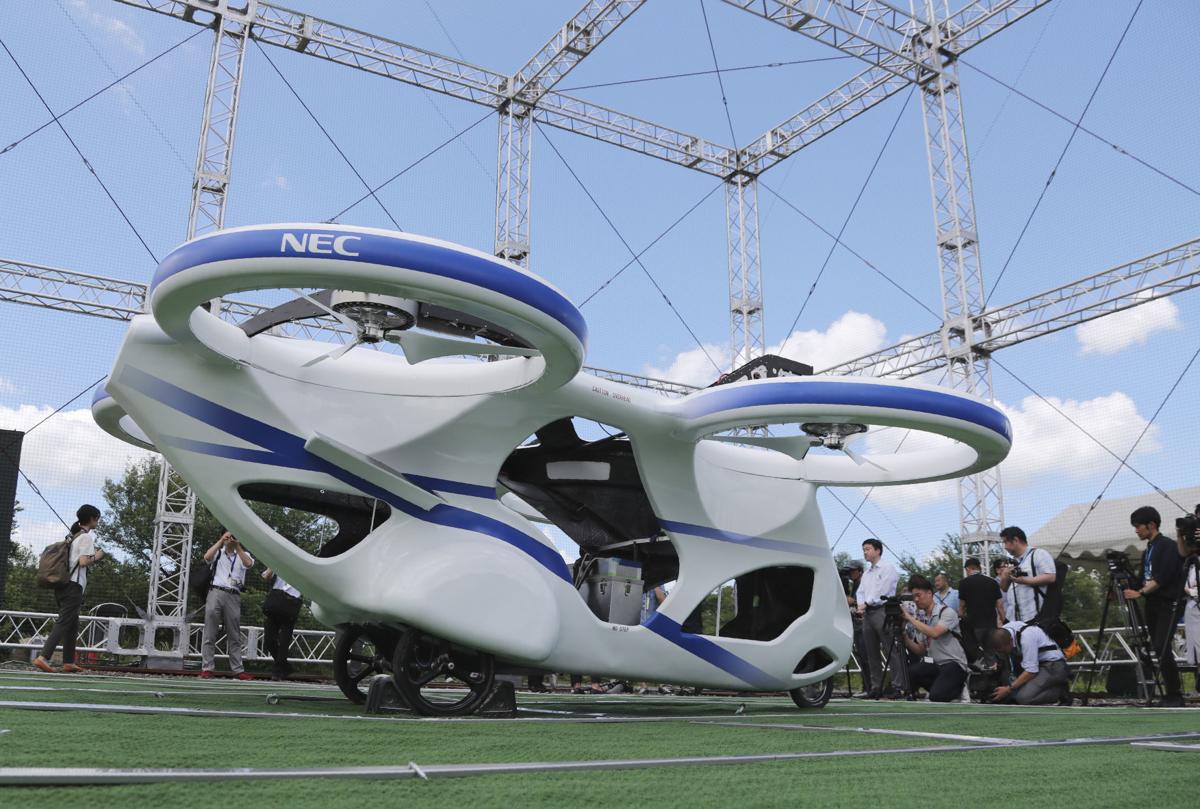 Japan's NEC shows 'flying car' hovering steadily for minute Business