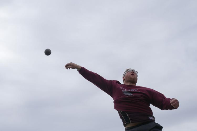 Track and field athletes battle through wind to claim titles to start