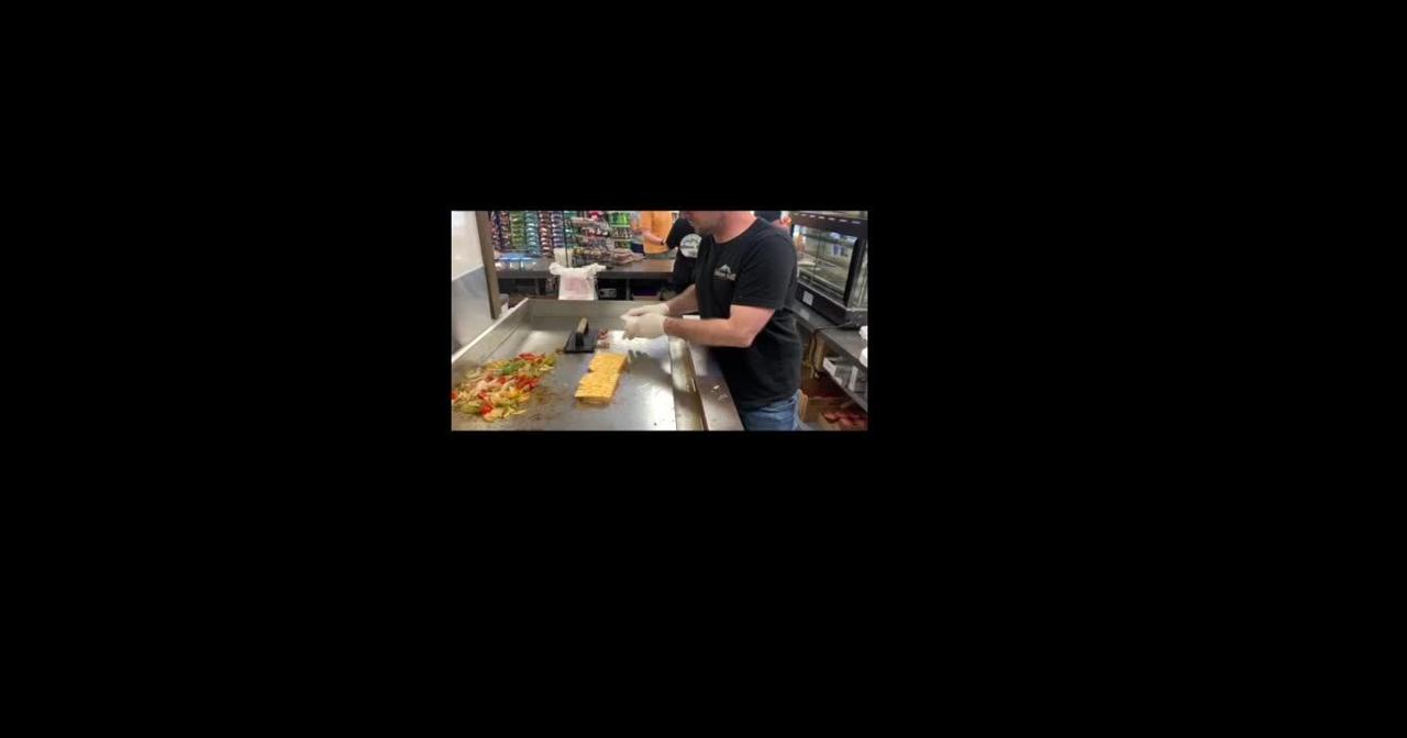 Helova Deli coowner Justin Brennan preparing a Fiery Melt