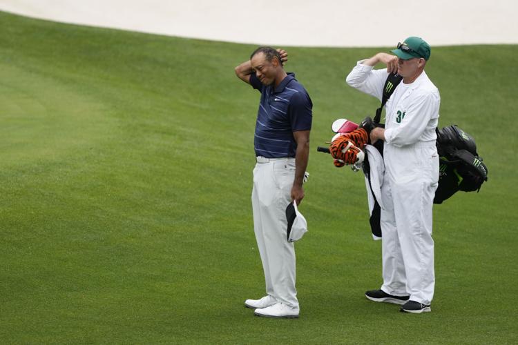 Masters suspends play Saturday; Tiger Woods in last place