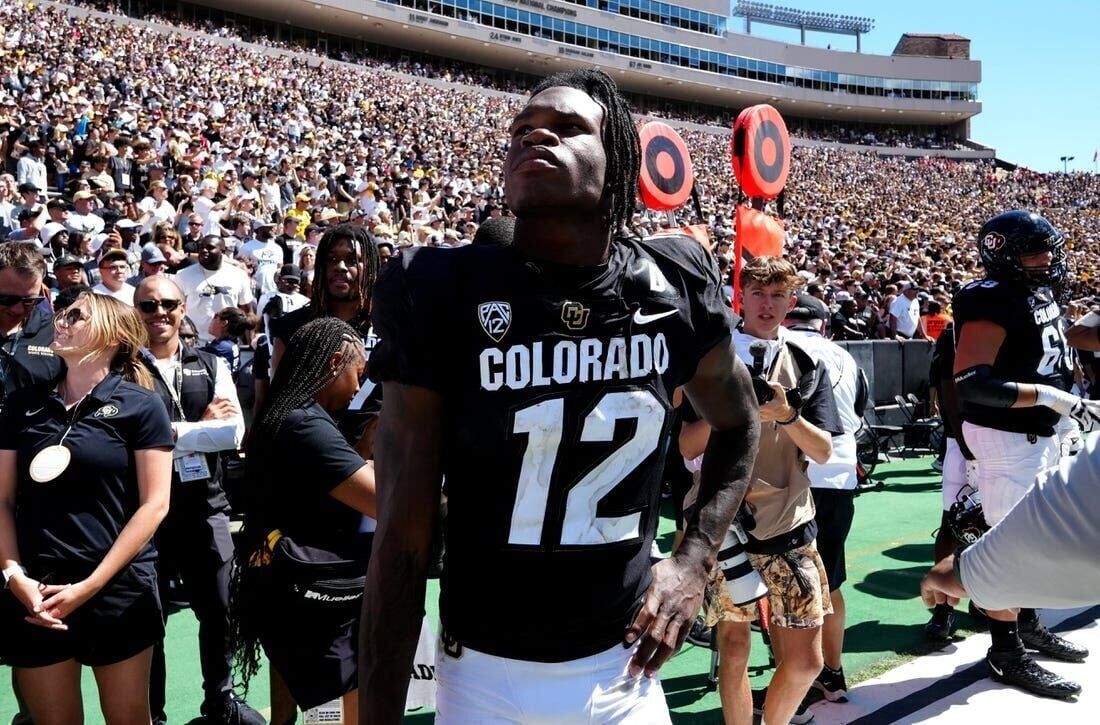 Baltimore Ravens cornerback Deion Sanders lines up against the