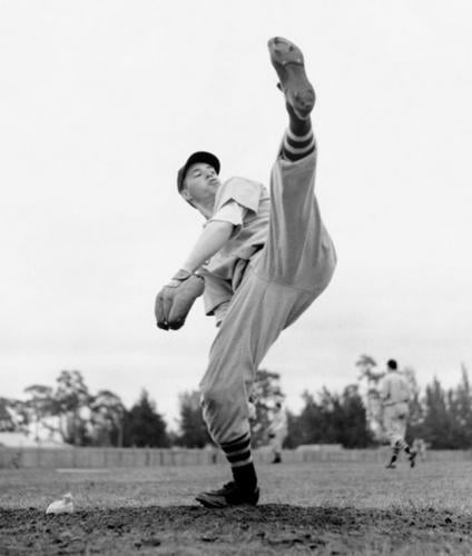 Bob Feller, former Cleveland Indian great, blasts a strike past an opposing  batter during a game in which he struck out 18 men at Efate in the New  Hebrides in 16 May