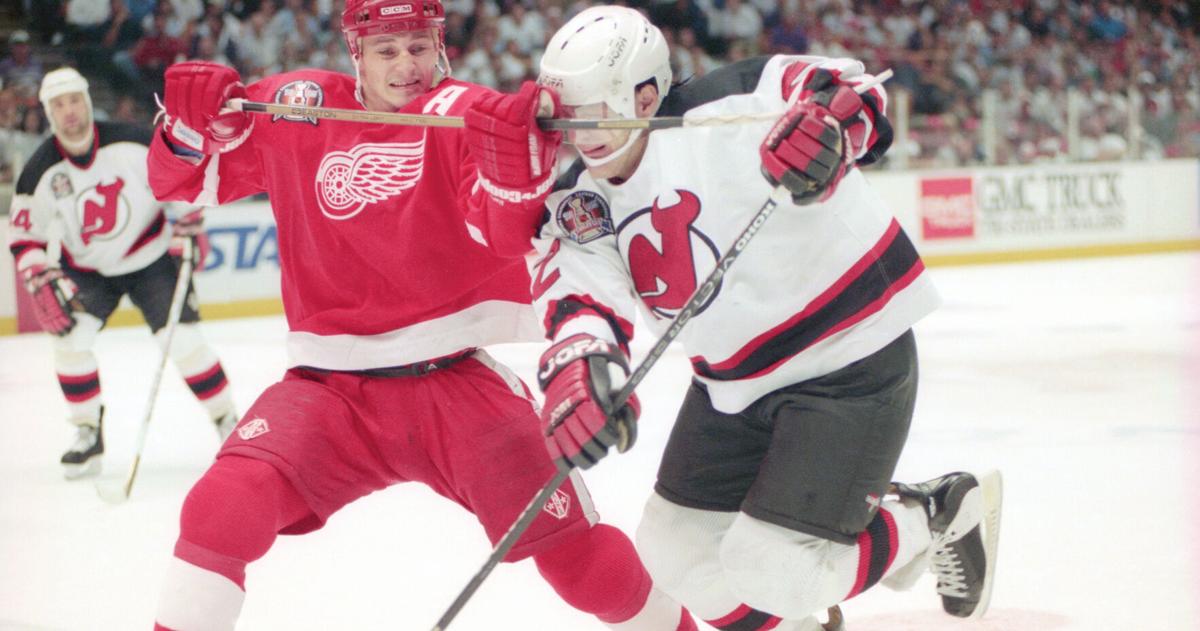 Detroit Red Wings' Rob DiMaio battles New Jersey Devils' Claude Lemieux during Game 4 of the Stanley Cup finals at Brendan Byrne Arena in East Rutherford, N.J., on June 24, 1995.
