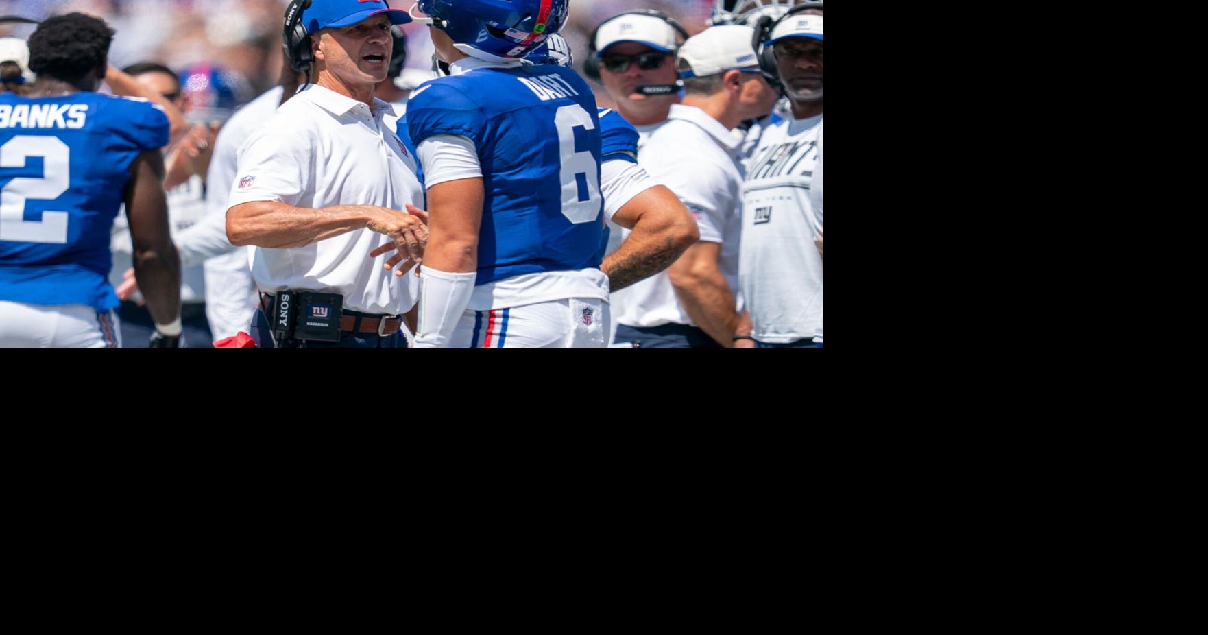 New York Giants head coach John Harbaugh chats with New York Giants quarterback Jaxson Dart (6) after a touchdown during a