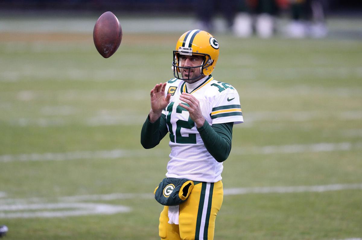 In this file photo, Green Bay Packers quarterback Aaron Rodgers warms up for a game against the Chicago Bears at Soldier Field on Jan. 3, 2021.