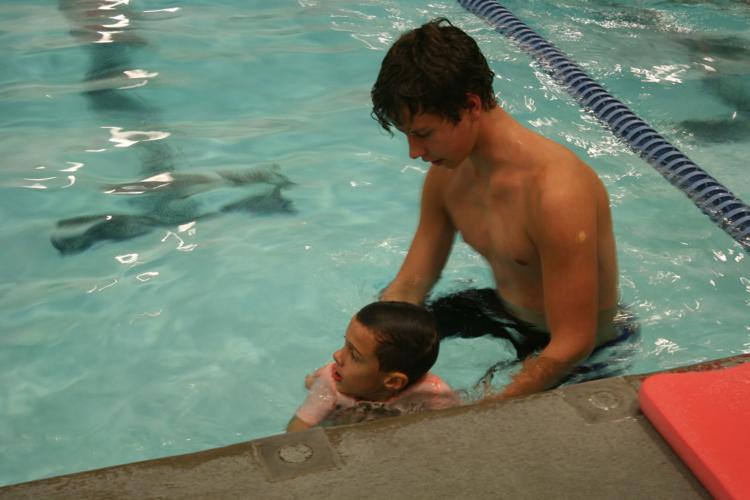 Lessons all around as Holy Spirit swimmers teach disabled children to