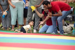 13-month-old Arjun Avidi crawling toward his parents during the Baby Waddle competition in Atlantic City