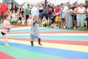 Collin Dyson speed waddles toward his family during the Baby Waddle event in North Wildwood