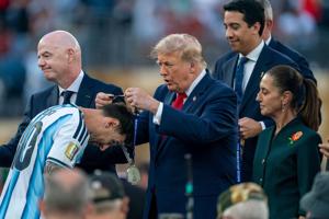 President Donald Trump places a medal on Lionel Messi at the FIFA World Cup final at MetLife Stadium in East Rutherford, New Jersey