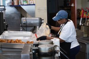 Cook preparing halal food at Nana's Good Eats restaurant on Michigan Avenue in Atlantic City before opening