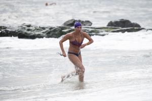 Ivy Slavinski from Sea Girt emerging from the surf during the Cape May Point Women's Lifeguard Challenge