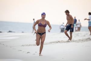 Ivy Slavinski from Sea Girt emerging from the ocean after swimming during the Cape May Point Women's Lifeguard Challenge