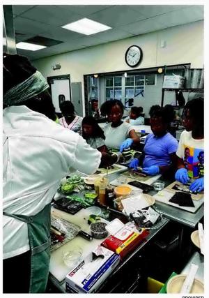 Hard Rock chef Leslie Daniel teaches sushi preparation to children at Boys & Girls Club Atlantic City