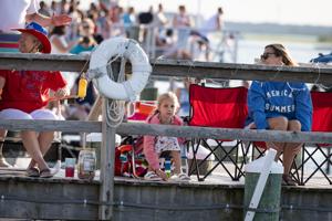 Decorated boats illuminated during the Night In Venice boat parade in Ocean City, New Jersey