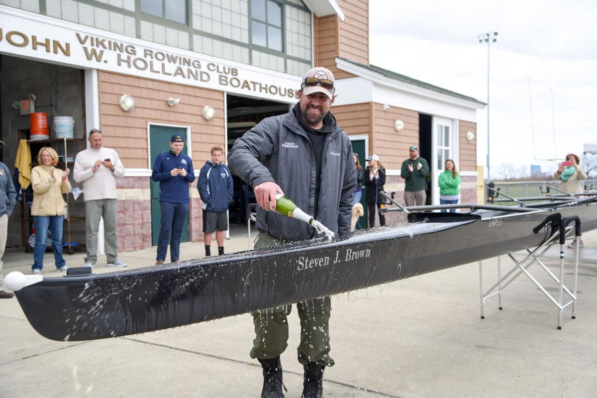 Mainland Crew Eric Somershoe, from Ventnor, christens a new crew boat dedicated to former Mainland Crew Coach Steven J. Brown during the First Annual Back Bay Challenge held at the Dr. John W. Holland Boathouse in Ventnor. Dave Griffin / for the Press