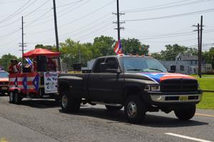 Crowds and parade participants celebrating at the 60th annual Vineland Puerto Rican Festival parade on Landis Avenue in Vineland, New Jersey