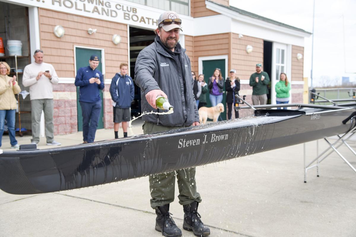 Mainland Crew Eric Somershoe, from Ventnor, christens a new crew boat dedicated to former Mainland Crew Coach Steven J. Brown during the First Annual Back Bay Challenge held at the Dr. John W. Holland Boathouse in Ventnor. Dave Griffin / for the Press