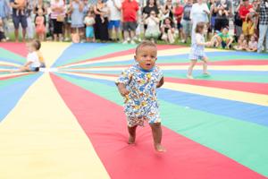 Collin Dyson speed waddles toward his family during the Baby Waddle event in North Wildwood