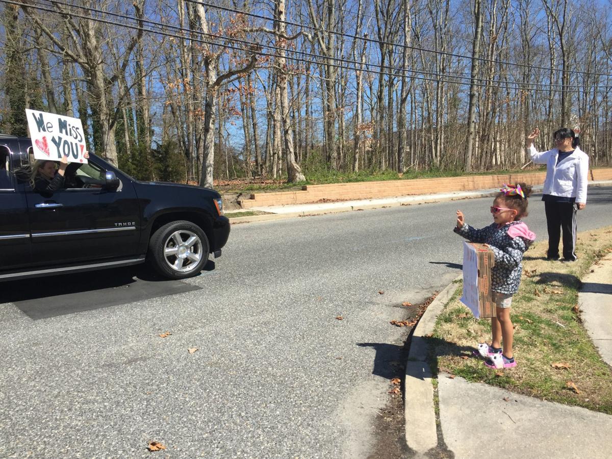 Somers Point students and parents wave to Dawes Avenue School staff as they parade in their cars around the city Thursday, March 26, 2020.