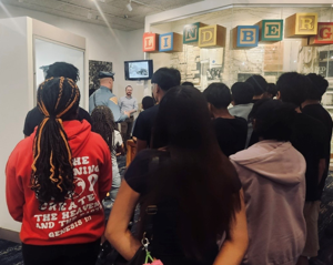 New Jersey State Police Trooper Lucas Buzby speaks with Atlantic City and Pleasantville students at State Police Headquarters