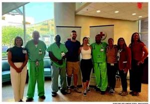 Atlantic City police Sergeant Christian Ivanov and his wife Bryanna pose with AtlantiCare hospital staff during a blood drive.